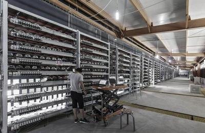 Large-scale Bitcoin mining farm with rows of miners and cooling systems